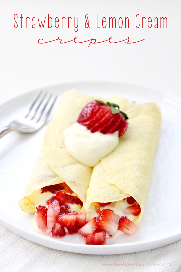 Strawberry & Lemon Cream Crepes on a white plate with a fork.