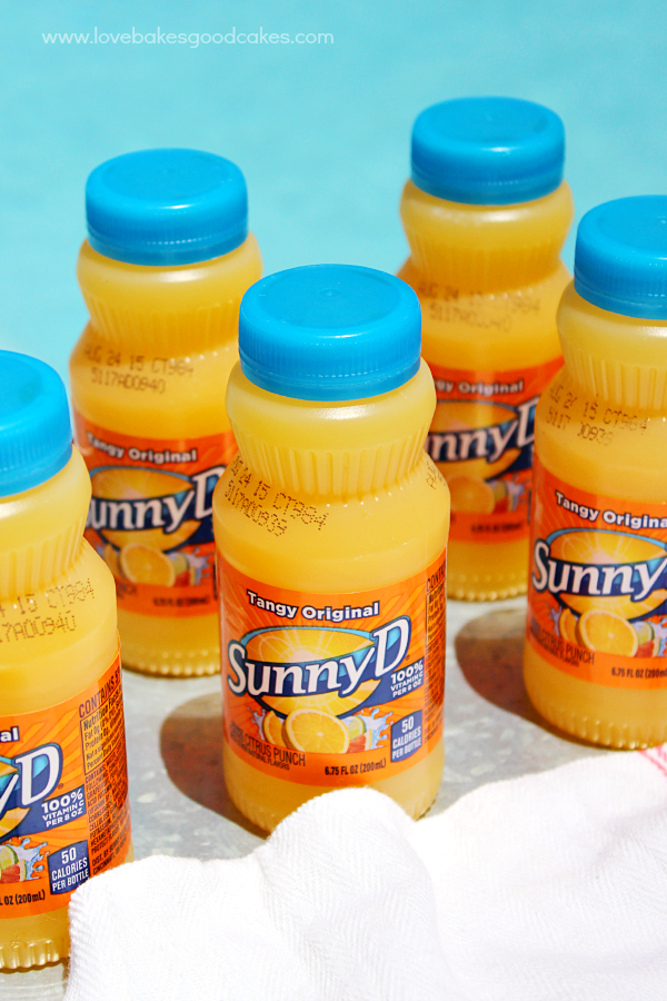 Sunny Delight bottles sitting on a pool deck.