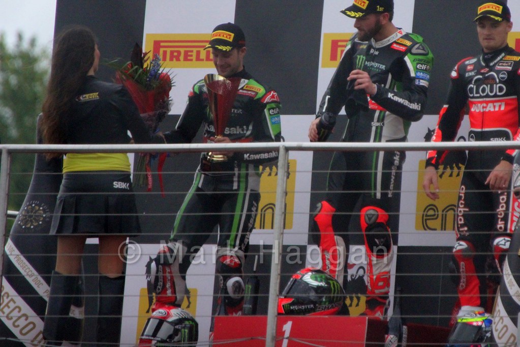 Jonathan Rea receives his trophy on the podium from the first World Superbikes race at Donington, May 2015