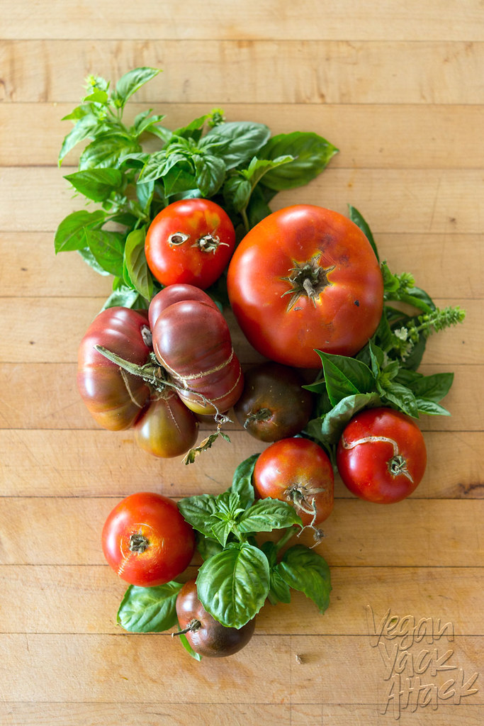 Tomatoes and fresh basil on a cutting board