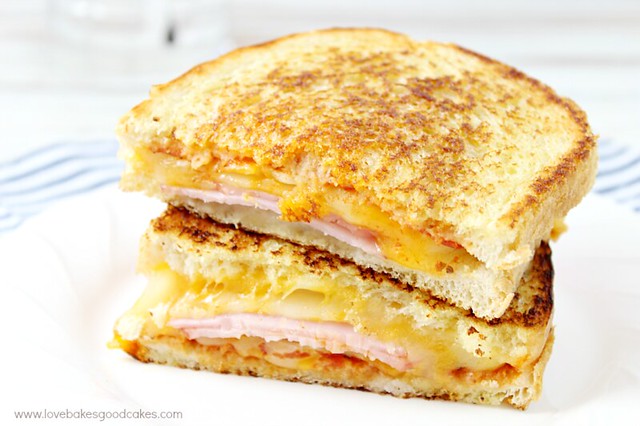 Hawaiian Pizza Grilled Cheese Sandwich stacked up on a plate.