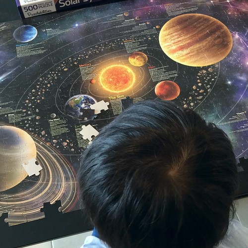 Family time... Working on the solar system jigsaw puzzle.